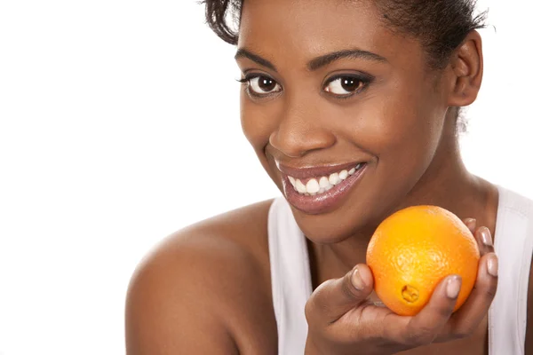 Woman with an orange — Stockfoto