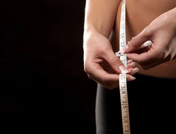 Woman measuring her waist — Stock Photo, Image