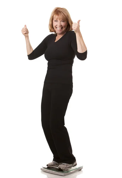 Kobieta stojąca na wadze — Zdjęcie stockowe
