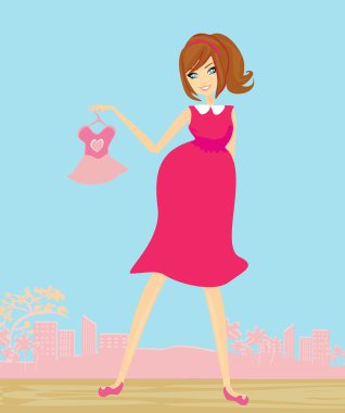 Güzel hamile kadın yeni bebek taşıyıcısı için alışveriş yapıyor.