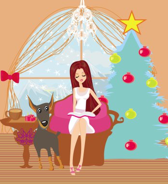 Kız bir kış Noel sabahında kitap okuyor.