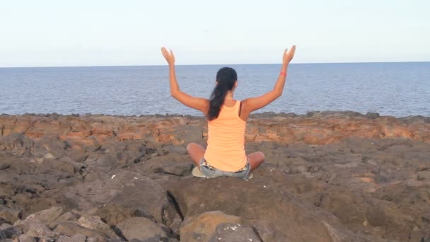 Yoga woman on a beach rock — Stock Video