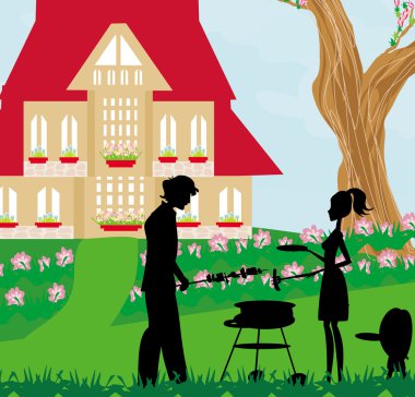 Aile bahçede barbekü yapıyor.