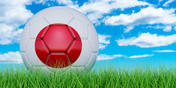 Soccer ball with Japanese flag on the green grass against blue sky, 3D rendering