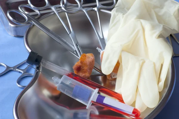 Containers with cultures of blood and medical instruments — Stock Photo, Image