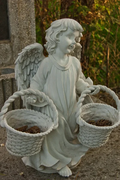 Angel statue tombstone with two baskets — Stock Photo, Image