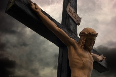 Jesus Christ on cross with dramatic sky clipart