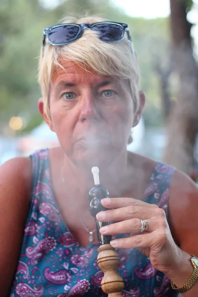 Smoking a hookah waterpipe — Stock Photo, Image