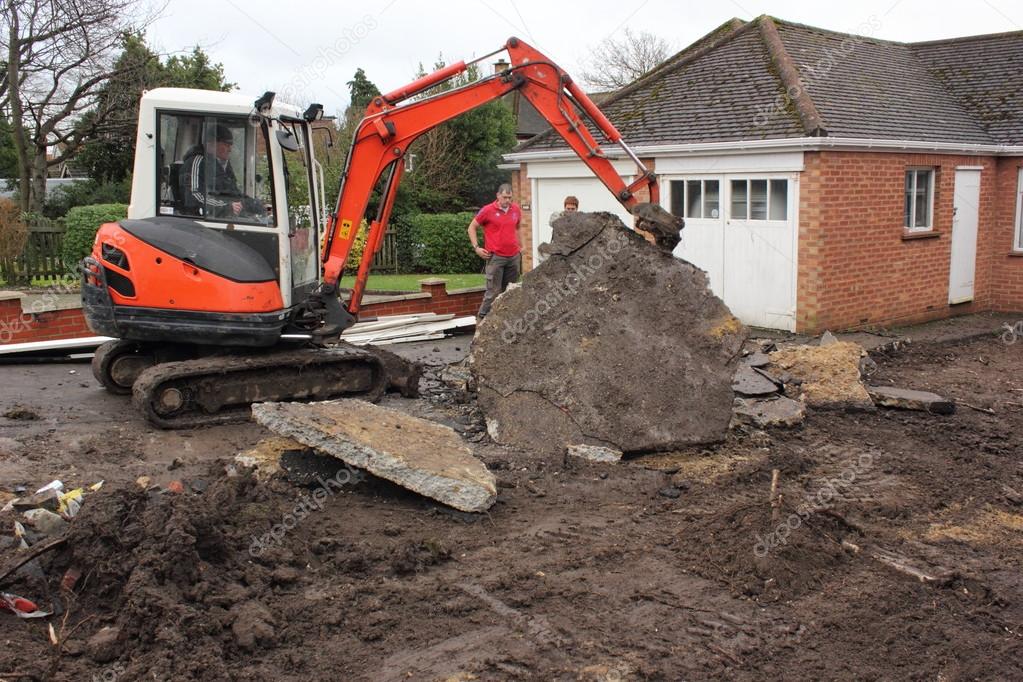 A mini digger excavating a driveway Stock Editorial Photo © 1markim