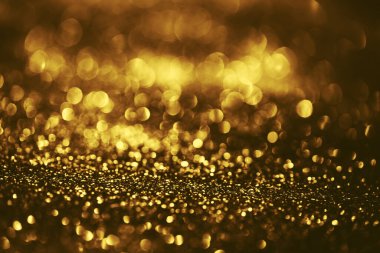 Altın parıltılı bokeh aydınlatma dokusu doğum günü, yıldönümü, düğün, yeni yıl arifesi veya Noel için soyut arkaplanı bulanıklaştırdı