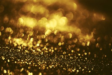 Altın parıltılı bokeh aydınlatma dokusu doğum günü, yıldönümü, düğün, yeni yıl arifesi veya Noel için soyut arkaplanı bulanıklaştırdı