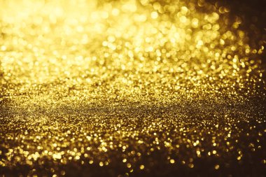 Altın parıltılı bokeh aydınlatma dokusu doğum günü, yıldönümü, düğün, yeni yıl arifesi veya Noel için soyut arkaplanı bulanıklaştırdı