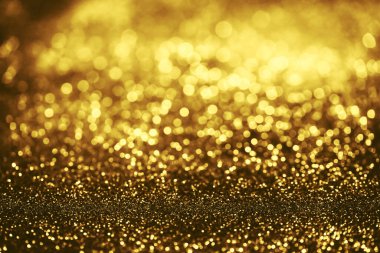 Altın parıltılı bokeh aydınlatma dokusu doğum günü, yıldönümü, düğün, yeni yıl arifesi veya Noel için soyut arkaplanı bulanıklaştırdı
