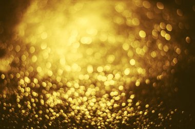 Altın parıltılı bokeh aydınlatma dokusu doğum günü, yıldönümü, düğün, yeni yıl arifesi veya Noel için soyut arkaplanı bulanıklaştırdı