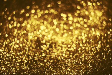Altın parıltılı bokeh aydınlatma dokusu doğum günü, yıldönümü, düğün, yeni yıl arifesi veya Noel için soyut arkaplanı bulanıklaştırdı
