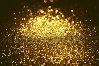 Altın parıltılı bokeh aydınlatma dokusu doğum günü, yıldönümü, düğün, yeni yıl arifesi veya Noel için soyut arkaplanı bulanıklaştırdı