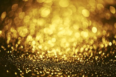 Altın parıltılı bokeh aydınlatma dokusu doğum günü, yıldönümü, düğün, yeni yıl arifesi veya Noel için soyut arkaplanı bulanıklaştırdı