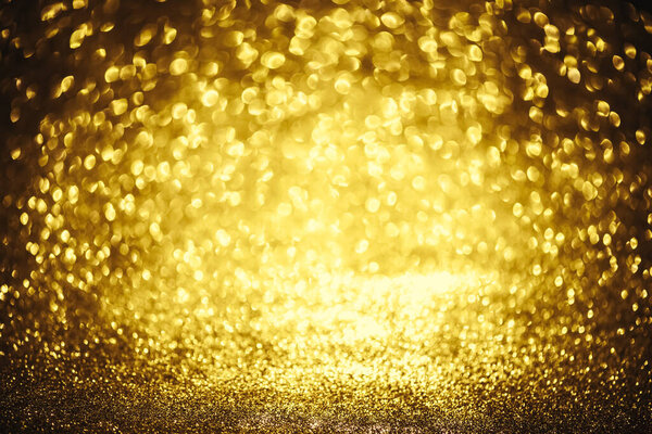 Golden glitter bokeh lighting texture Blurred abstract background for birthday, anniversary, wedding, new year eve or Christmas