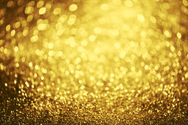 Golden glitter bokeh lighting texture Blurred abstract background for birthday, anniversary, wedding, new year eve or Christmas