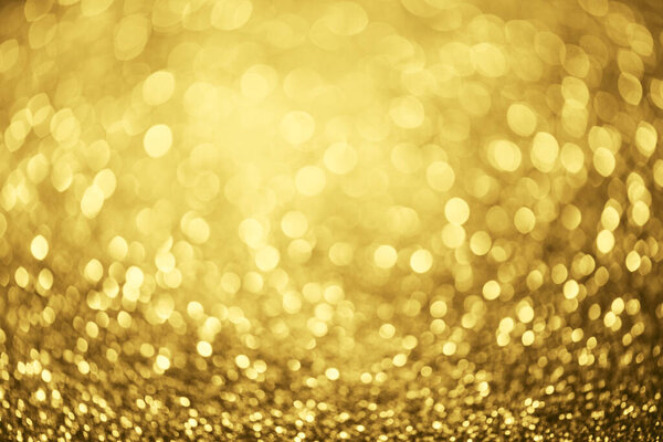 Golden glitter bokeh lighting texture Blurred abstract background for birthday, anniversary, wedding, new year eve or Christmas