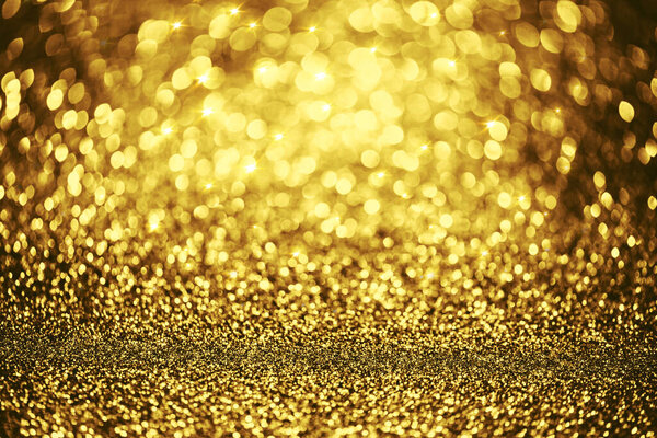 Golden glitter bokeh lighting texture Blurred abstract background for birthday, anniversary, wedding, new year eve or Christmas