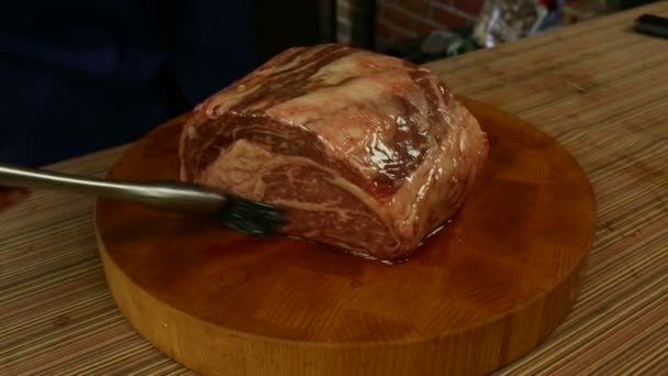 Wrijven olie op rib roast — Stockvideo