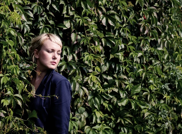 Ragazza in piedi vicino all'arbusto — Foto Stock