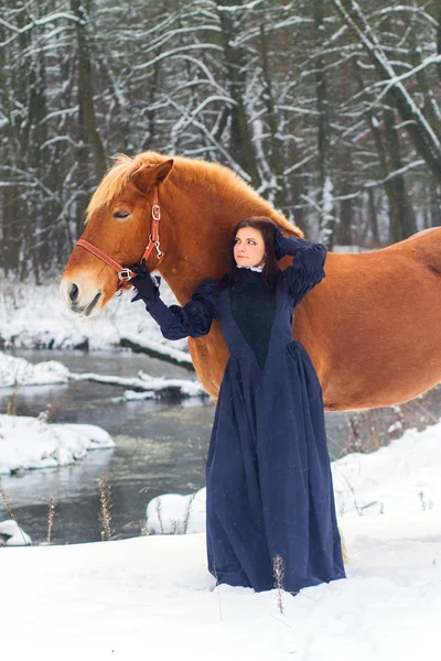 Beautiful woman and horse in winter — Stock Photo, Image