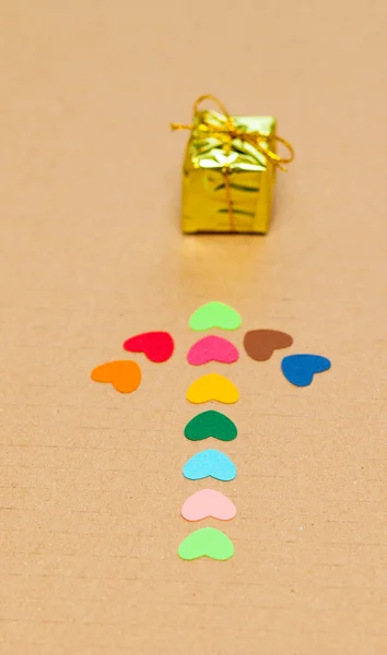 Βέλος από πολύχρωμα χαρτί εστίες με μικρό δώρο — Φωτογραφία Αρχείου