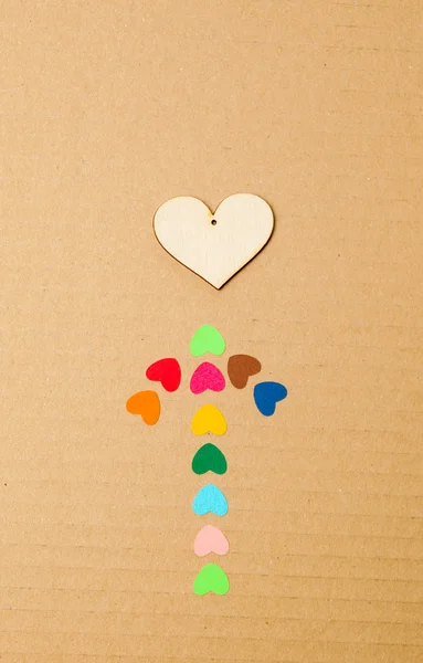 Arrow from multicolored paper hearths with wood hearth — Stock Photo, Image