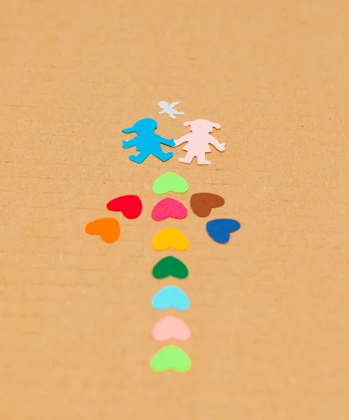 Nyíl kandallók különböző színű papír és papír fiú és lány angyal — Stock Fotó