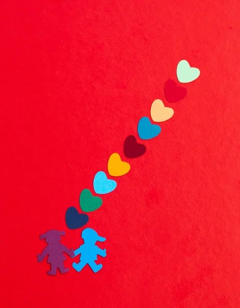 Mångfärgade papper pojke och flicka med mångfärgade pappers härdarna — Stockfoto