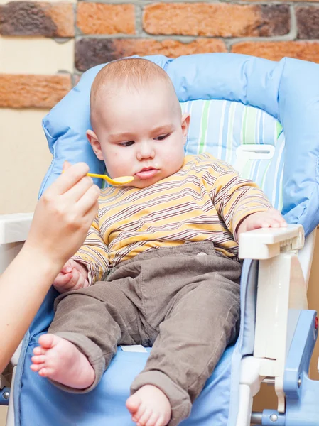 Eating little boy is looking very angry — Stock Photo, Image