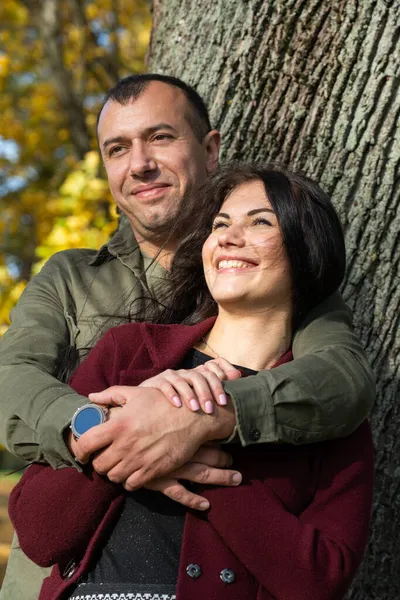 美丽的年轻夫妇在一个阳光灿烂的秋天的森林里 — 图库照片