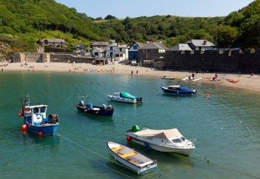Boats Polkerris harbour Cornwall England near St Austell and Par on a beautiful summer day clipart