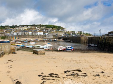 Mousehole harbour Cornwall England UK Cornish fishing village with blue sky and clouds clipart