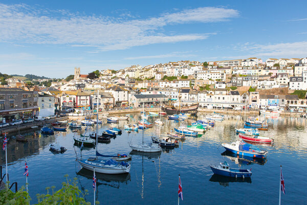 View of Brixham harbour Devon England with boats on a calm day with blue sky