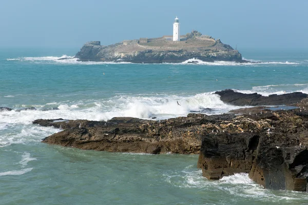 Lighthouse and island with sea breaking over rocks Godrevy Cornwall England UK — Stock Photo, Image