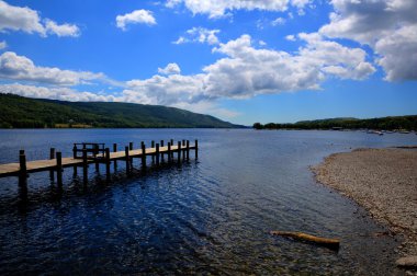 Coniston Water Lake District England uk with mountains and blue sky and white clouds on a beautiful summer day