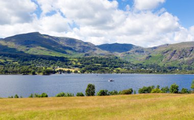 Coniston Water Lake District England uk with mountains and blue sky and white clouds on a beautiful summer day