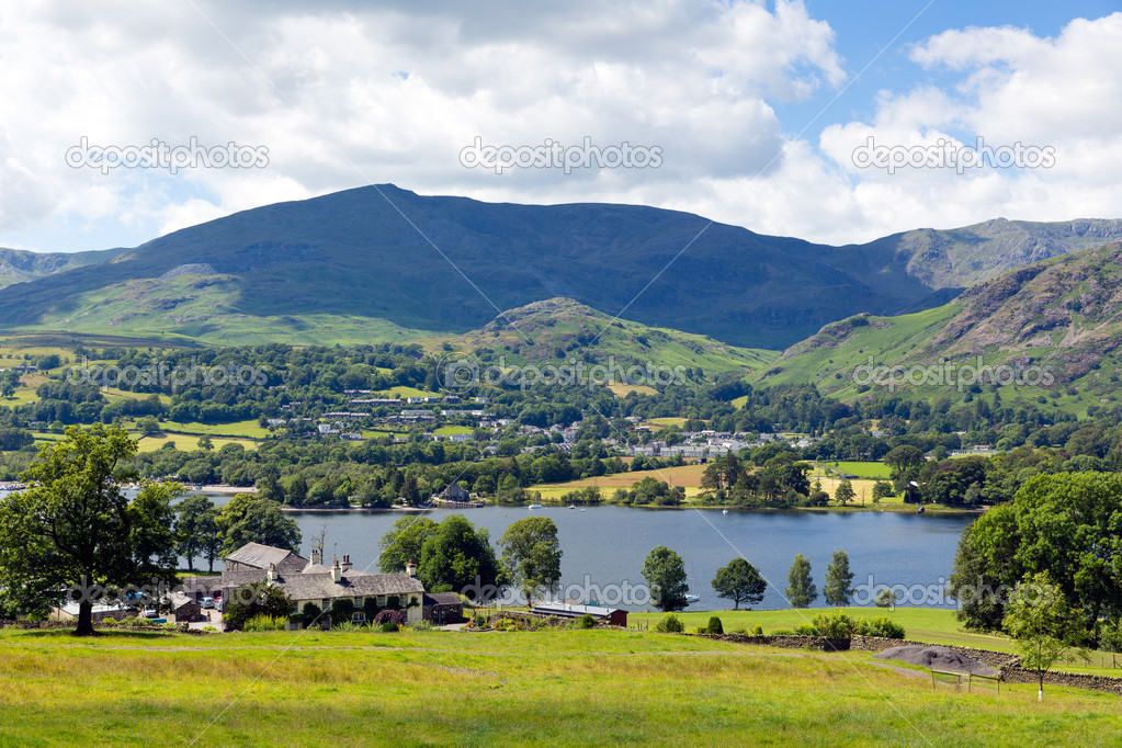 Coniston Water Lake District England uk with mountains and blue sky and white clouds on a beautiful summer day