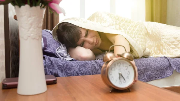 Sleepy Sleepless Woman Reluctantly Reaches Out Blanket Alarm Clock — Stock Photo, Image