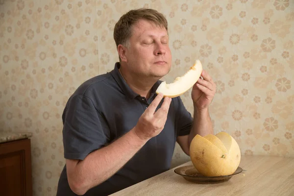 Man Inhales Scent Melon Closing His Eyes Pleasure — Stockfoto