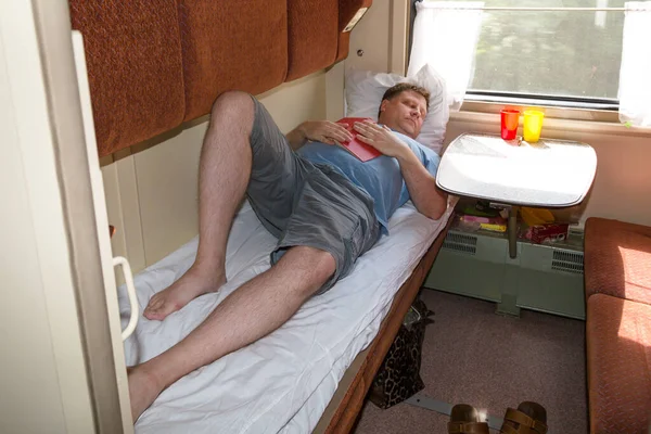 Adult Blond Man Years Old Lying Train Compartment Reading Book — Stock Photo, Image