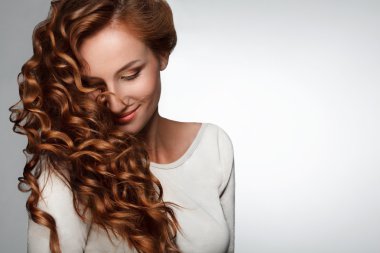 Red Hair. Woman with Beautiful Curly Hair clipart