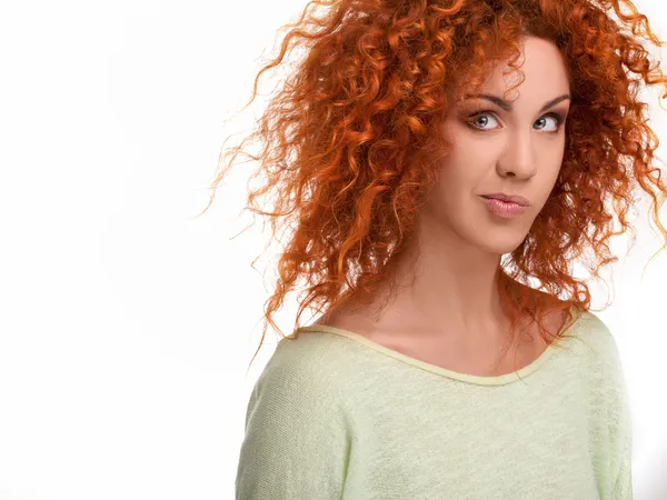 Рыжие волосы. Смешная женщина с кудрявыми длинными волосами против белого бэк-гро — стоковое фото