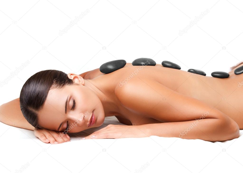 Stone Massage. Beautiful Woman Getting Spa Hot Stones Massage. S