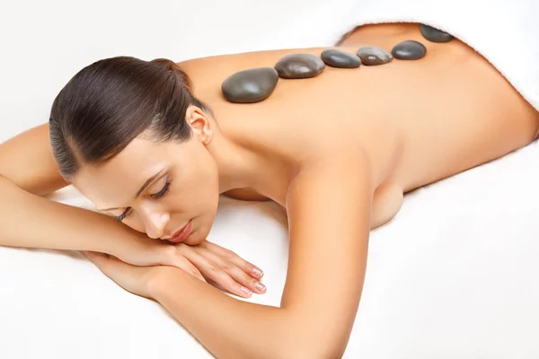 Stone Massage. Beautiful Woman Getting Spa Hot Stones Massage in — Stock Photo, Image