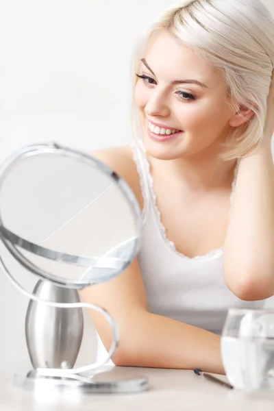 Woman Looking at Her Face in the Mirror