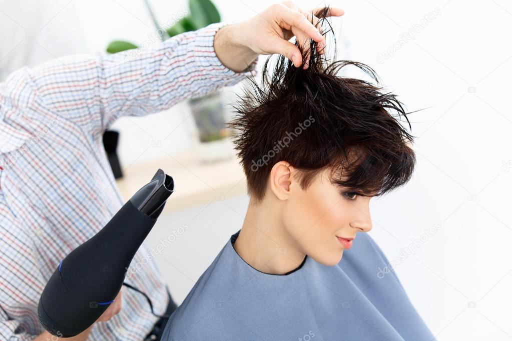 Hairdresser Using Dryer on Woman Wet Hair